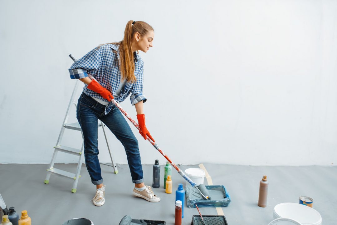 Painter working on an exterior wall